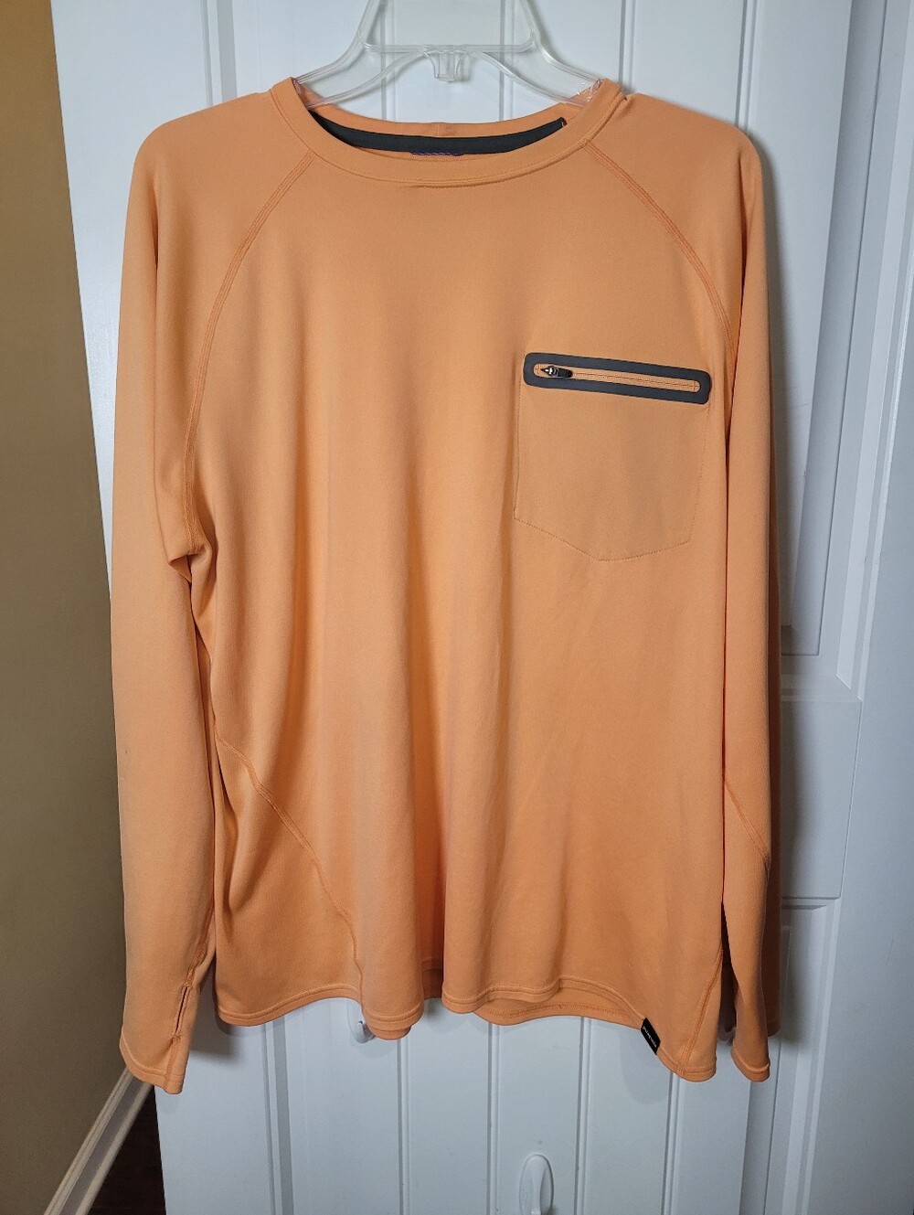 Patagonia Men's pullover SURF Long-Sleeve Crewneck Shirt in Peach Orange.